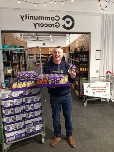 A man holding a pallet of Easter eggs at the Community Grocer in Manchester